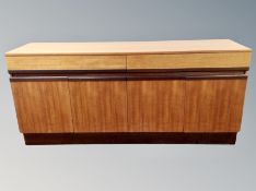 A teak sideboard, fitted cupboards and drawers,