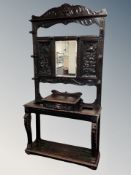 A 19th century carved oak Green Man hall stand with mirror back,