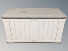 A plastic garden storage box containing several metal garden ornaments