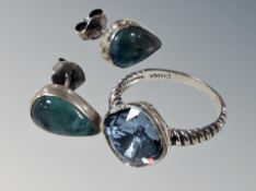 A silver ring and pair of earrings