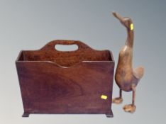 A carved wooden duck and a magazine stand