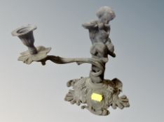 A 19th century cast metal cherub candlestick