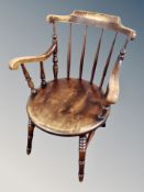 A stained beech spindle back armchair