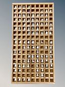 A large wooden thimble stand containing a large quantity of thimbles