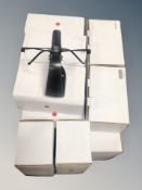 A quantity of boxed magnetic glasses stands by Never Lost