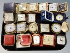 A collection of travel timepieces in cases