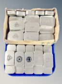 A collection of metal tins bearing various emblems including Super Heroes,