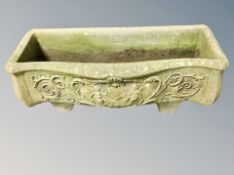 A weathered concrete garden classical planter,