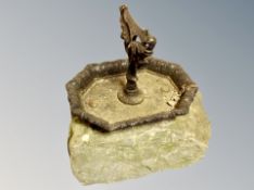 A weathered stone and cast iron boot scraper,