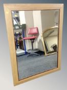 A contemporary oak bevelled mirror,