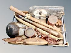 A collection of ethnographic items, carved masks,