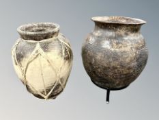 Two earthenware vase, one on metal stand,