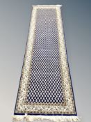 A Ghom design runner, on indigo ground,