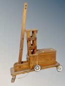 A child's pine pull-along crane