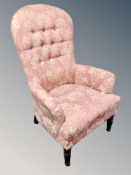 A Victorian style button backed salon armchair