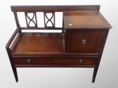 A reproduction mahogany telephone table,