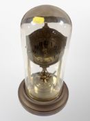 A brass clock under dome,
