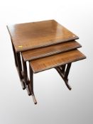 A reproduction mahogany nest of tables,