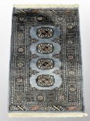 A Lahore Bokhara rug on blue ground 96 cm x 63 cm