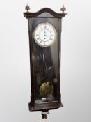 A Continental eight day wall clock with enamel dial,