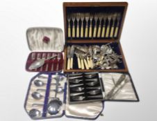 An oak canteen of cutlery together with three further boxed cutlery sets, pair of knife rests,