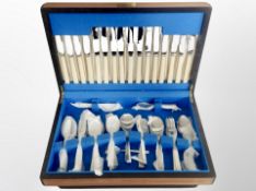 A teak canteen of stainless steel cutlery