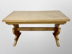 A Danish blond oak pull out refectory dining table and set of four chairs in striped upholstery