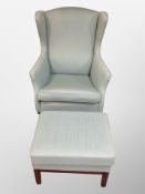 A late 20th century Danish wingback armchair and matching footstool in turquoise fabric
