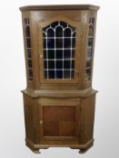 A Danish oak leaded glass corner cabinet