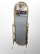 A brass oval cheval mirror,