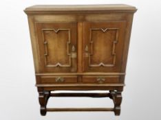 A Danish oak double door cabinet on stand,