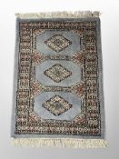 A Lahore Bokhara rug on blue ground 75 cm x 49 cm