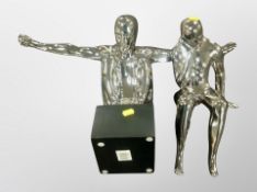 A cast chrome sculpture of a man with arms outstretched, height 45 cm,