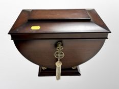 A contemporary sarcophagus-form jewellery casket with key,