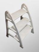 A painted wooden library step,