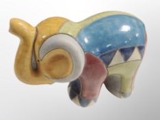 A South African Raku glazed earthenware figure of an elephant, signed BR to base,