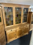 A Danish blond oak leaded glass triple door sideboard,