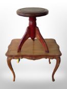 A continental walnut coffee table and a circular stool