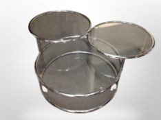 A Scandinavian chrome and glass three tier adjustable coffee table,
