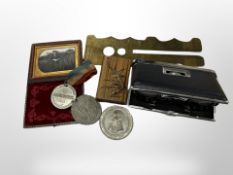 A photograph of a soldier in tooled leather, velvet-lined case,