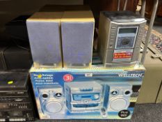 A Sanyo micro hifi with four speakers and a boxed Welltech hifi