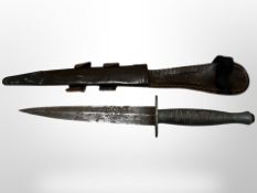 A Fairbairn Sykes third pattern fighting knife in sheath