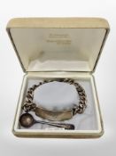 A silver identity bracelet engraved with the name 'Stu',