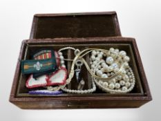 A faux crocodile leather jewellery box containing a small quantity of costume jewellery,