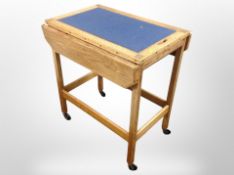 An Edwardian oak drop leaf trolley,