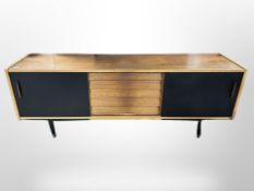 A 1970's teak ebonised low sideboard,