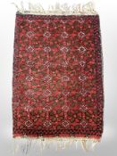 A small Eastern hearth rug 71 cm x 43 cm