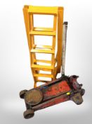 A hydraulic jack and two metal bike stands