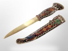 A decorative Eastern brass dagger with enamelled grip and sheath