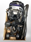 A box of roller blades, badminton rackets, dumbells,